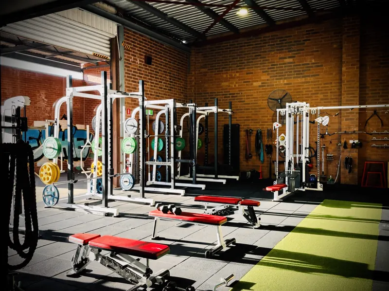 Squat racks and bumper plates in the strength room