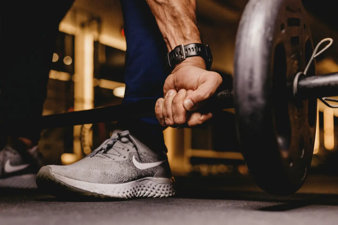 Member gripping a barbell