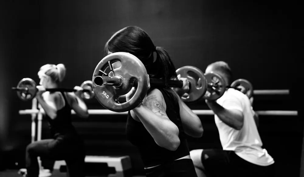 Four people working out on rowing machines
